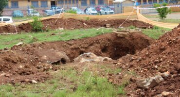 Some of the huge open trenches across from Hlanganani Primary School. Insert: Although there are warning signs, some of the barricading have already started to collapse.