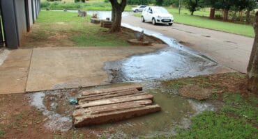 Sewage streams from this manhole near the corner of Chrome Street and Lang Street.