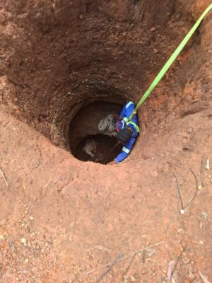  Jacob Molote being lowered to the trapped dog.