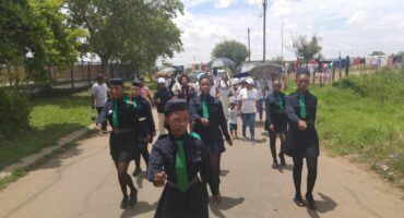 Community members taking part in the march through Greenspark's streets as part of the land dedication.