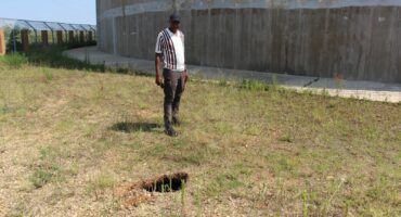 Welile Fihla points out the new sinkhole close to the Khutsong reservoir. Although the hole on top of the sinkhole is still small, there is a huge cavity underneath.