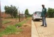 Kabelo Klaas Masebeni shows how the sidewalk and street is much higher than his yard.