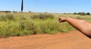 One of the residents, who do not want to be identified because they fear the attackers, shows how the criminals usually come from the direction of the main road to Potchefstroom.