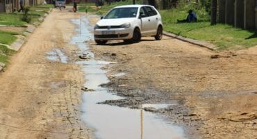 The ongoing sewage leaks have damaged the paved street.