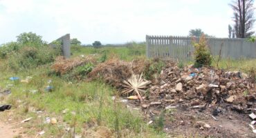This large heap of sand, building rubble and rubbish prohibits family members from entering the old graveyard.