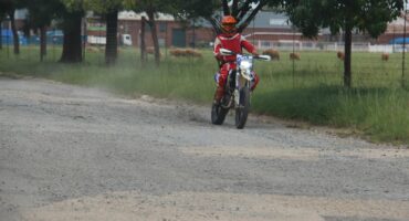 This off-road motorcyclist showed that sections of the street consist of more gravel and dust than tar.