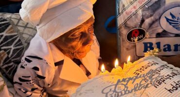 Left: Granny Elizabeth Monica Goitsemang Mangale with the special birthday cake that members of the Khutsong CPF gave her.