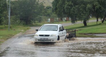 The driver of this car had to drive on the opposite side of the road to get to shallower water,