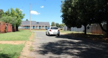 A motorist drives through the area of the usually quiet Marthinus Street, where the house robbery took place.