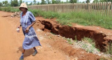 The upset resident whose house is closest to the sinkhole, Yvonne Morekudi, walking away from the cavity. Photo: Adele Louw