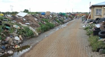 Huge amounts of rubbish along the road to the facility. Photo: Adele Louw