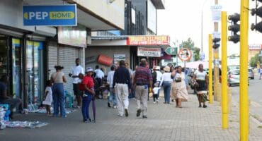Pedestrians on the busy sidewalk outside the Pep Home store, which was struck by robbers over the weekend. Photo: Adele Louw