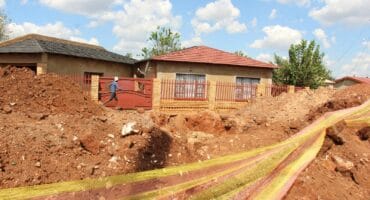 Some residents on the other side of the trench almost cannot get into their yards. Photo: Adele Louw