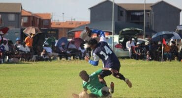 This player of Owasome (in green) did not let the ball fall into the hands of his City All Stars opponent. Photo: Adele Louw (Carletonville and Fochville Herald)