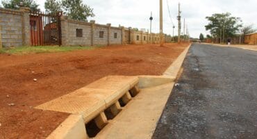 The tarred road surface is much lower than the sidewalks.