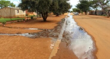 The sewage streamed over the sidewalk into the street. Photo:Adele Louw (Carletonville and Fochville Herald)