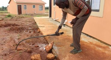 The contractors also left this leaking water pipe. Residents fear that the leaking water may cause a sinkhole.