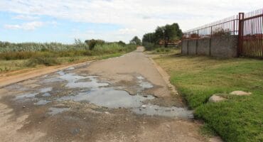 Sewage streaming down Danie Theron Street in Fochville has also caused damage to the road. Photo: Adele Louw (Carletonville and Fochville Herald)