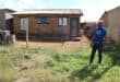 Buti Elliot Mtembu of OMO in front of one of several houses with asbestos roofs in Skopas in Khutsong. Photo: Adele Louw (Carletonville and Fochville Herald)