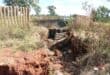 The fence separating the canal from Khutsong South has started to collapse into the sinkhole. Photo: Adele Louw (Carletonville and Fochville Herald)