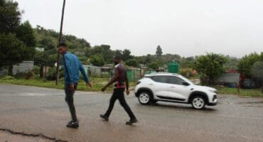 Residents of the Mpahla Village informal settlement walks in the road leading to the farm where the crime took place. Photo: Adele Louw (Carletonville and Fochville Herald)
