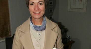 Linda Braukmann-Saayman with one of the beautifully wrapped mini fruit cakes. Photo: Adele Louw (Carletonville and Fochville Herald)