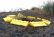 The sinkhole is still open, and some of the barriers around it have started melting during a recent veld fire. Photo: Adele Louw (Carletonville and Fochville Herald)