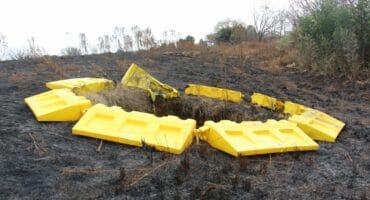 The sinkhole is still open, and some of the barriers around it have started melting during a recent veld fire. Photo: Adele Louw (Carletonville and Fochville Herald)