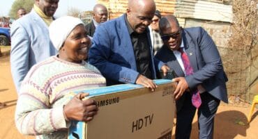 The Deputy Minister of Communications and Digital Technologies Mondli Gungubele and Gauteng Premier Panyaza Lesufi, handed a new television set instead of only a decoder to a Khutsong South pensioner Nowayilesi Dinizulu. Photo: Adele Louw (Carletonville and Fochville Herald)