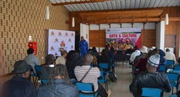 Local artists being addressed during the meeting.