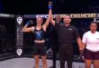 The referee lifts Charmaine Venter's hand triumphantly into the air after her win.