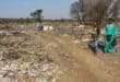 Concerned residents Lunga Situta and Thabiso Mafusini at the massive rubbish dump that recently started just outside Wedela. Photo: Adele Louw (Carletonville and Fochville Herald)