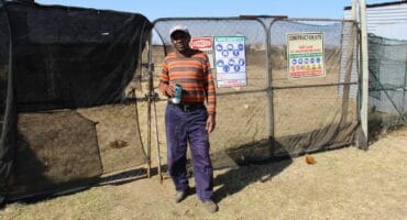 A supervisor at the project, Daniel Nokwane, in front of the yard with unused pieces of clear-view fencing that is not being used while the project is stalling. Photo: Adele Louw (Carletonville and Fochville Herald)