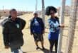Community activist Lerato Gumede shows the green cable tie that is allegedly supposed to show that everything is in order with the house's paperwork. Despite this, the Gauteng Department of Human Settlements wants to evict the residents.
