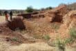 Concerned residents, Lunga Zituta and Mike Mohoza, at the massive hole behind Wedela Ext 4. Photo: Carletonville and Fochville Herald