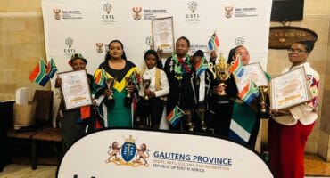 Dipuo Qupe (second from left) and some of the school's learners with other winners at the Kool 2B South African National Flag Colours of National Pride Patriotism Awards for Social Cohesion.