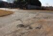 The faded stop sign and potholes on the road surface at the corner of Caledon and Vaal Streets. Photo: Adele Louw (Carletonville and Fochville Herald)