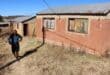 Zituta walks past another empty house. The house next to it has already been occupied by a resident previously looking for a home. Photo: Adele Louw (Carletonville and Fochville Herald)