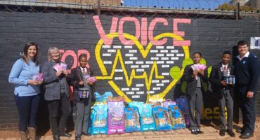 A staff member of the Carletonville SPCA, Adriaan van Niekerk (right) received the donation from representatives of Westfields Primary School. Photo: Supplied