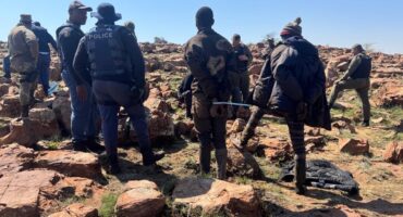 Law enforcers with suspects during the operation. Photo: SAPS