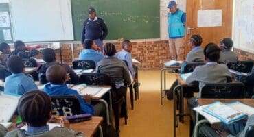 The learners listened intently to what the police members had to say.