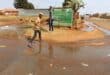Nelson Hlongwane and Donald Mohlamme making their way over the sewage leak at the corner of Hornbill and Spaniel Street.