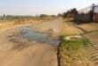 The street has been badly damaged by the leaking sewage. Photo: Adele Louw (Carletonville and Fochville Herald)