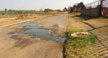 The street has been badly damaged by the leaking sewage. Photo: Adele Louw (Carletonville and Fochville Herald)