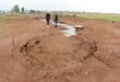 A large amount of sewage was leaking from the collapsing manhole and adjacent pipeline. Hlanganani Primary School is in the background. Insert: By October 5, the municipality or its contractor had dug a channel to reroute the leaking sewage. Photo: Adele Louw (Carletonville and Fochville Herald)