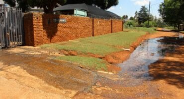 Sewage streaming from a manhole in 25th Avenue. Photo: Adele Louw (Carletonville and Fochville Herald)
