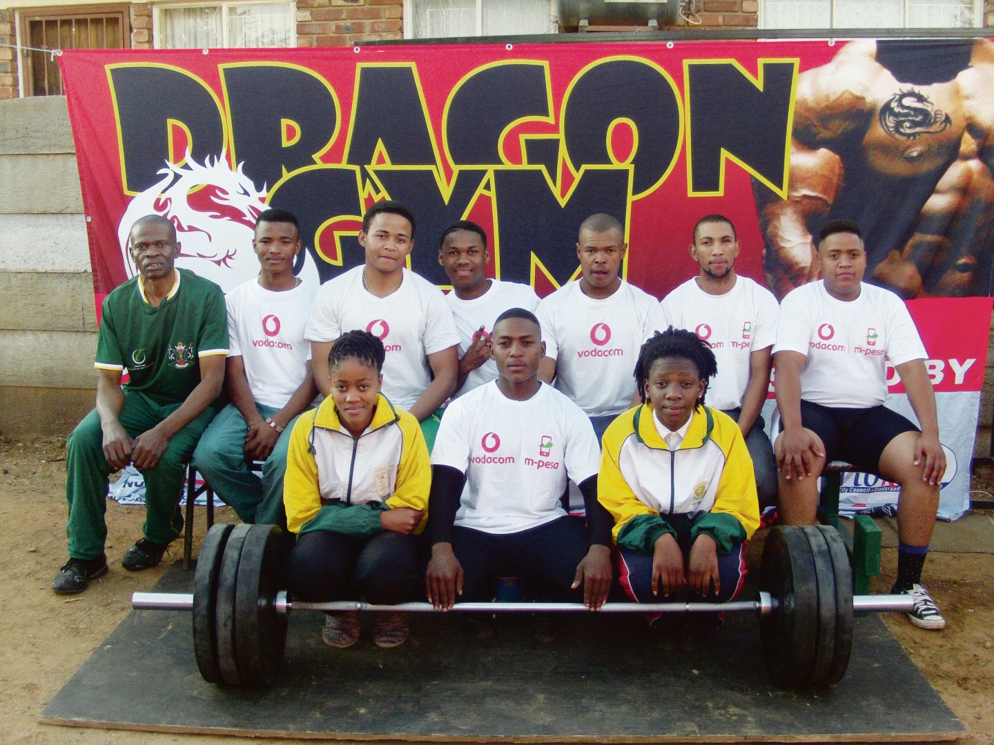 The group from Dragon Gym that went to Rustenburg. In front are Yvonne Khandenise (referee), David Tauhle and Katrein Tshellhane (officials). In the back row are Ephraim Khandenise (coach), Revaldo Matras, Jaydee Williams, Obert Booysen, Jonathan Hendricks, Eugen Foster and Reval de Kock.