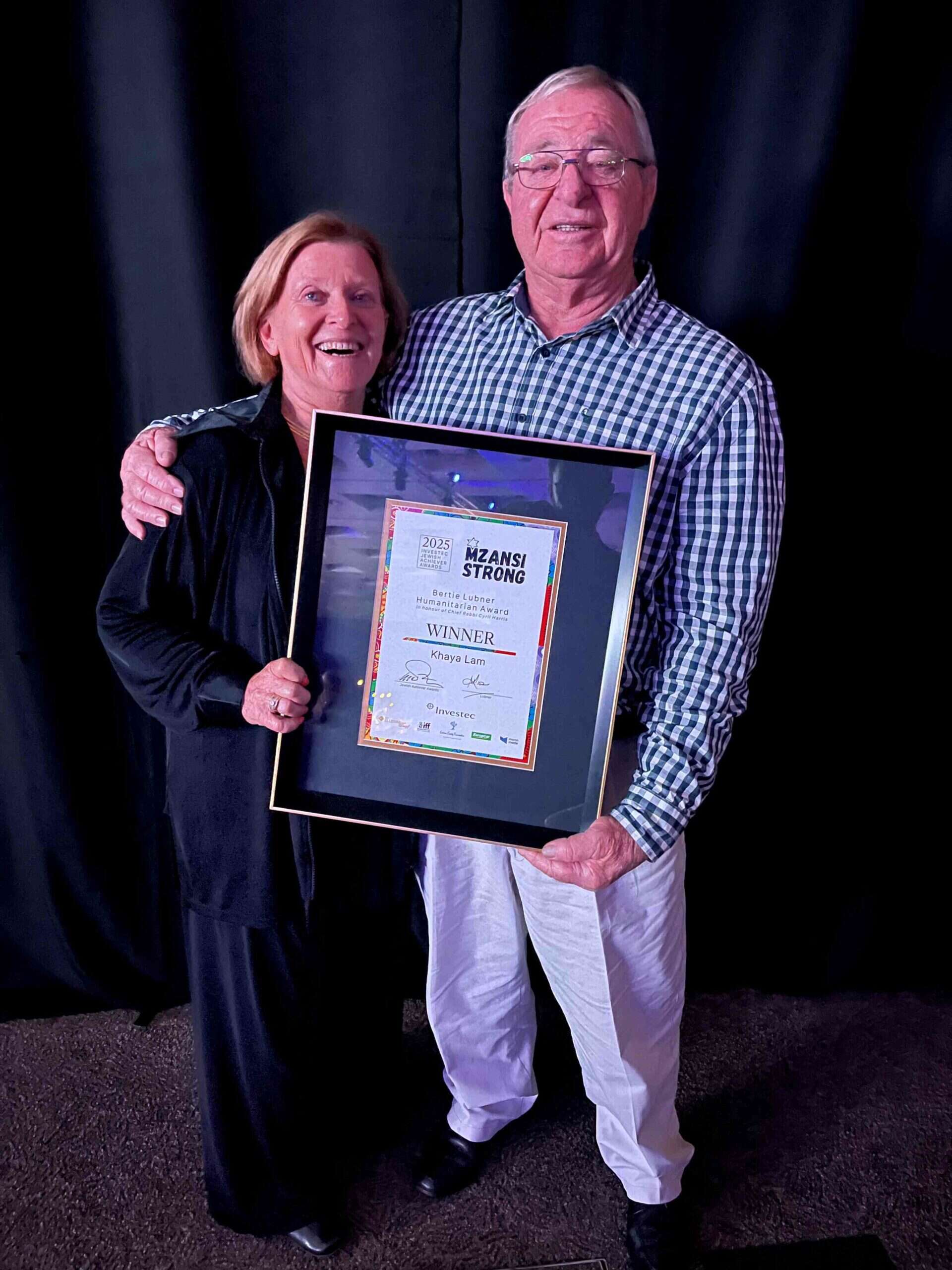 Searle and Lorna Sacks receiving Khaya Lam certificate.