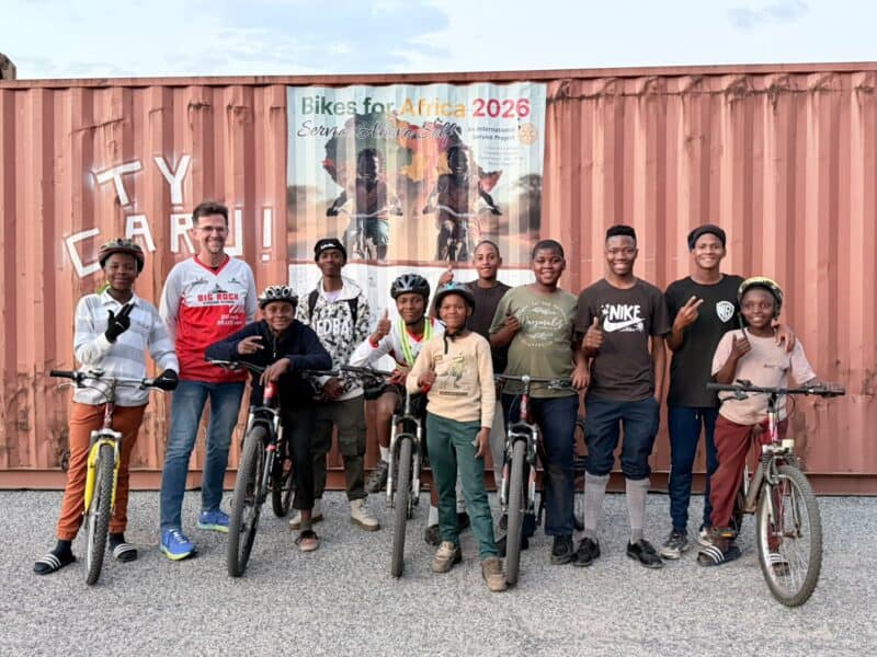 Big Rock Cyclists, together with Attie Koekemoer, in front of the container with bicycles received from Rotary the past Week. Photo: Supplied