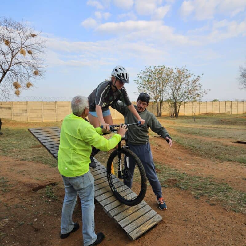 Big Rock Cyclists, together with Attie Koekemoer, in front of the container with bicycles received from Rotary the past Week. Photo: Supplied